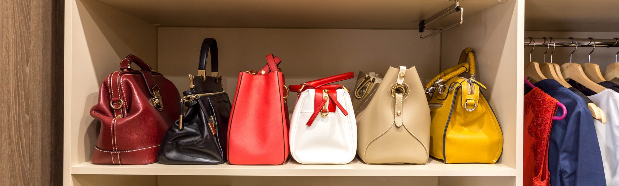 collection of handbags in woman`s wardrobe